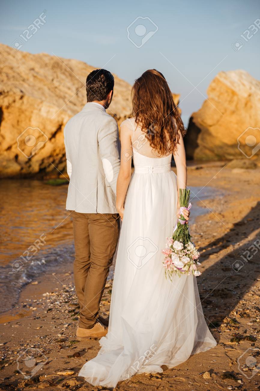 back view of a romantic happy married couple standing